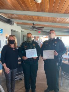 Two Lee County Sheriff Deputies receive their Deputy of the month award.